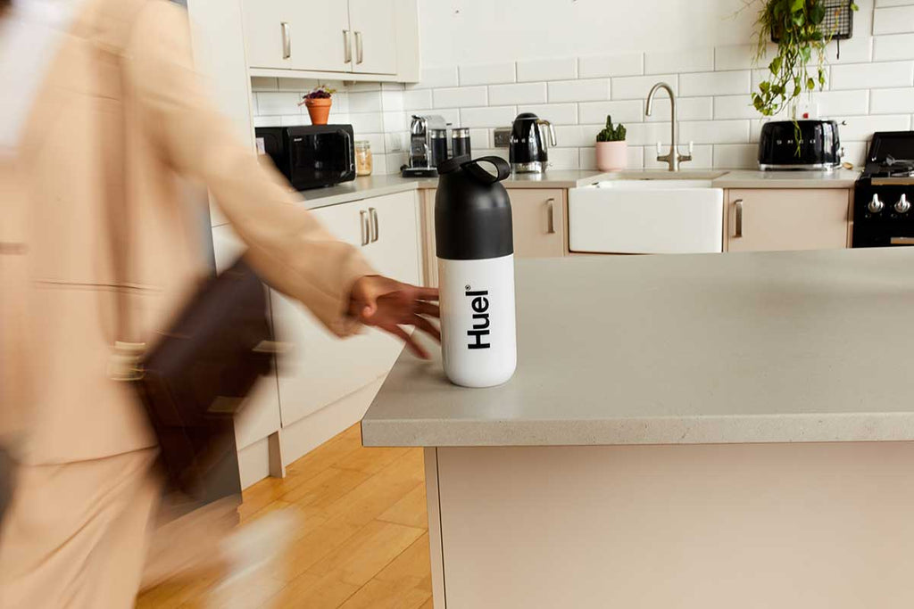 Women grabbing Huel shaker