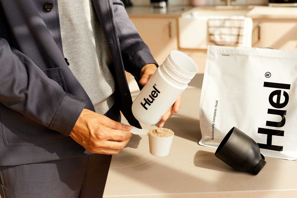 Man adding Huel to a shaker