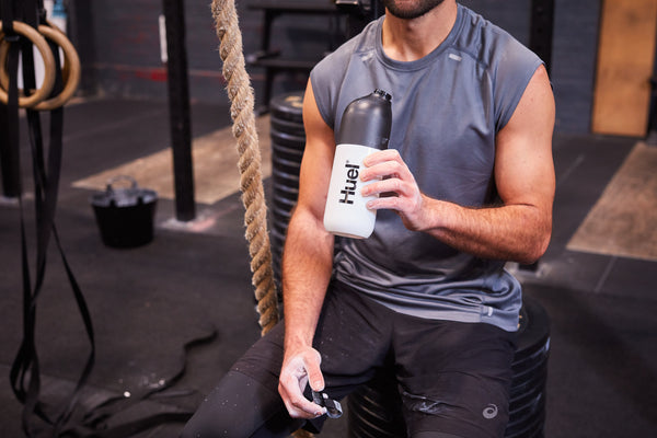 Man with Huel shaker in gym