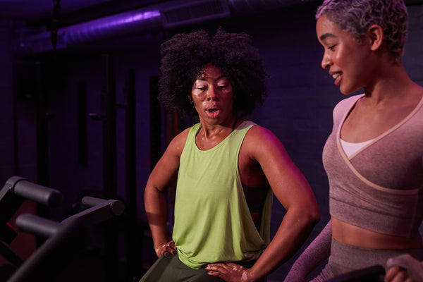 Two women talking in gym