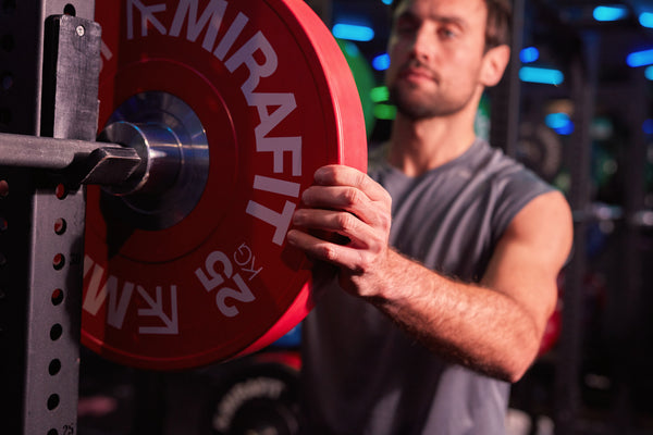 Man in gym with weight plate